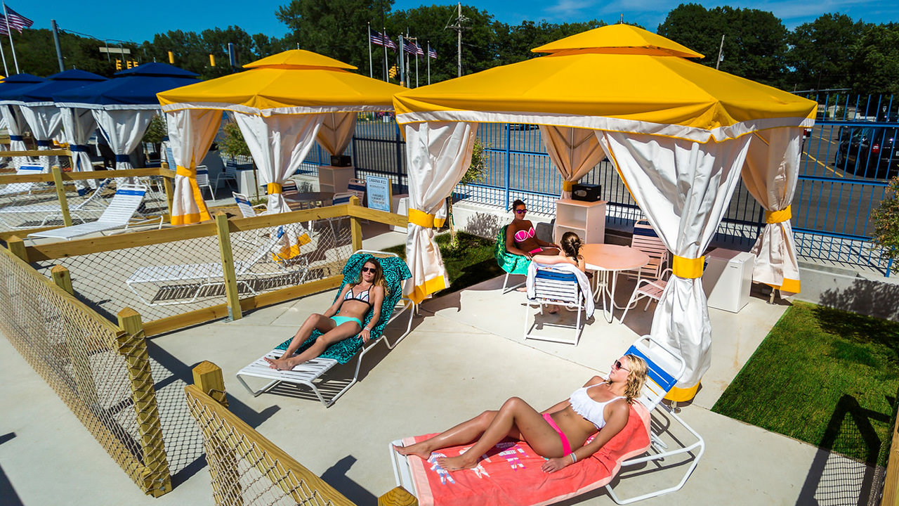 Guests lounging in the sun at the Wave Pool Cabanas