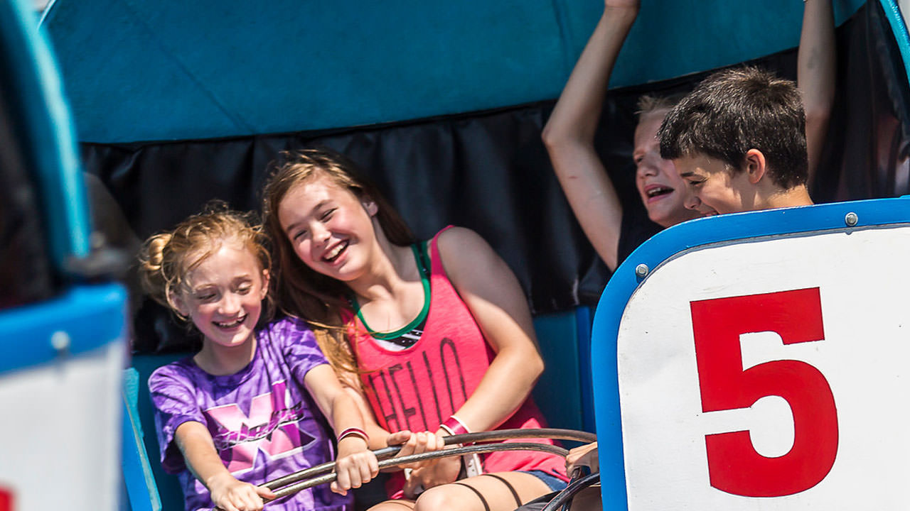 Guests riding the Tilt-A-Whirl